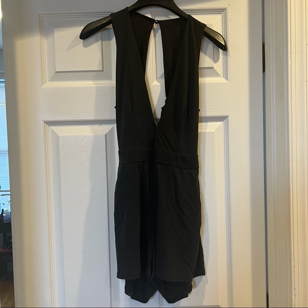 Deep v front, open tie-back black romper with pockets